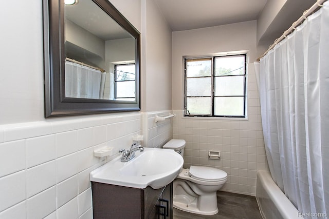 23461 Avon Rd, Oak Park, MI 48237 - full bath with tile walls, vanity, plenty of natural light, shower / bath combination with curtain, and wainscoting