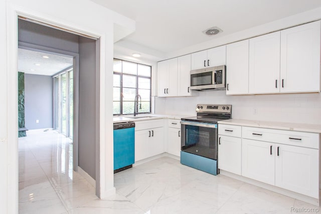 23461 Avon Rd, Oak Park, MI 48237 - kitchen featuring stainless steel appliances, light marble finish floors, white cabinetry, light stone countertops, and recessed lighting