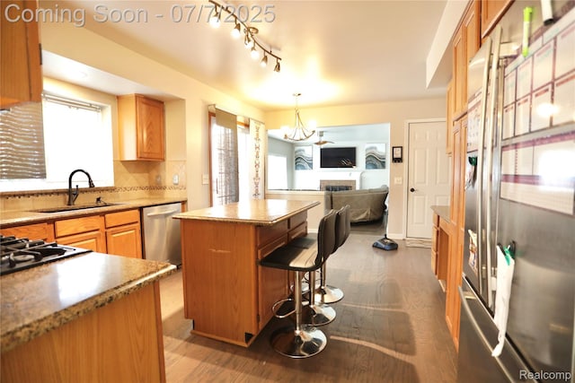 45587 Hanford Rd, Canton, MI 48187 - kitchen featuring appliances with stainless steel finishes, a kitchen island, wood finished floors, and a breakfast bar area