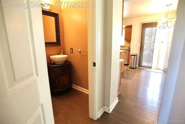 45587 Hanford Rd, Canton, MI 48187 - hall featuring dark wood finished floors and a chandelier