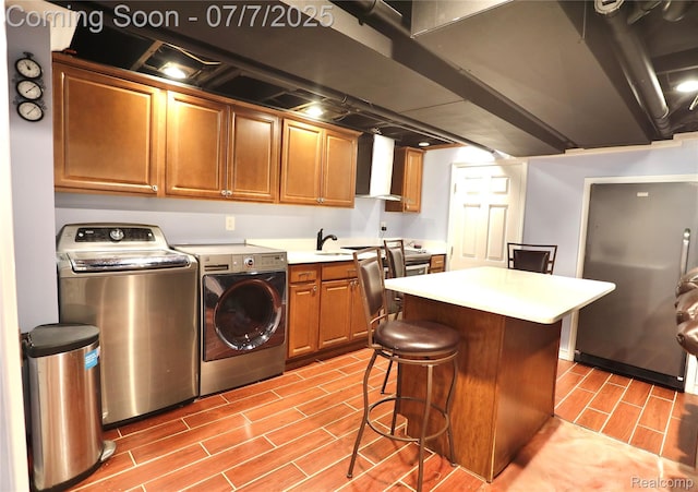 45587 Hanford Rd, Canton, MI 48187 - laundry room with washing machine and dryer, wood tiled floors, and cabinet space