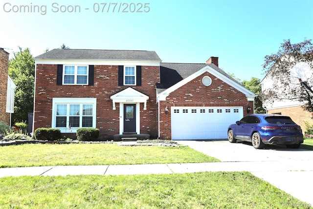 45587 Hanford Rd, Canton, MI 48187 - view of front facade featuring a garage, a chimney, a front lawn, concrete driveway, and brick siding