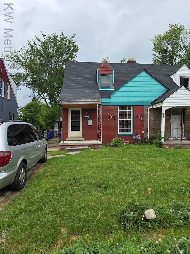 18639 Kelly Rd, Detroit, MI 48224 - view of front of property with brick siding and a front yard