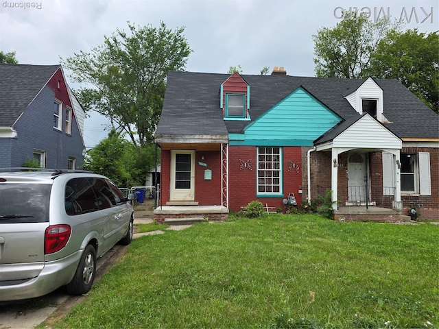 18639 Kelly Rd, Detroit, MI 48224 - view of front of property featuring brick siding, a front yard, and a chimney