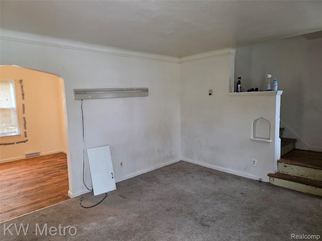 18639 Kelly Rd, Detroit, MI 48224 - empty room with carpet floors, stairs, and a wall mounted AC