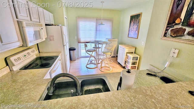 20059 Rodeo Ct, Southfield, MI 48075 - kitchen with white appliances, light wood-style flooring, and light countertops