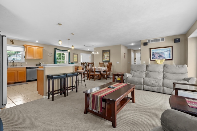 8181 Fawn Meadow Trl, Galesburg, MI 49053 - living room with healthy amount of natural light, light tile patterned floors, recessed lighting, and light colored carpet