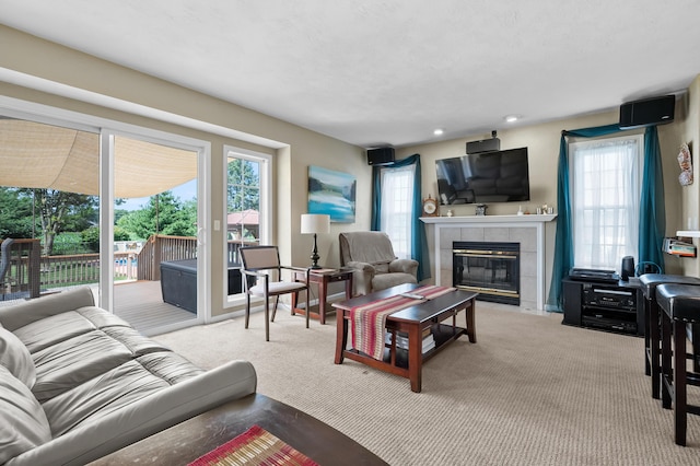 8181 Fawn Meadow Trl, Galesburg, MI 49053 - living area with a tile fireplace, carpet floors, and recessed lighting