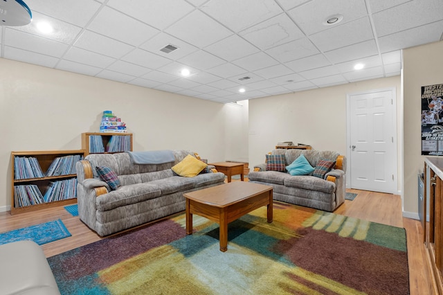 8181 Fawn Meadow Trl, Galesburg, MI 49053 - living room with wood finished floors, a paneled ceiling, and recessed lighting