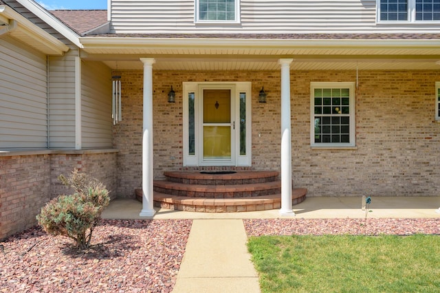 8181 Fawn Meadow Trl, Galesburg, MI 49053 - property entrance with brick siding, covered porch, and a shingled roof