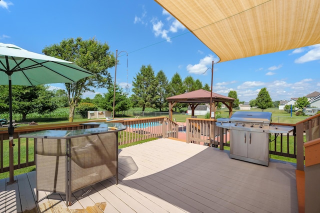 8181 Fawn Meadow Trl, Galesburg, MI 49053 - deck with a gazebo, a grill, a storage unit, and a lawn