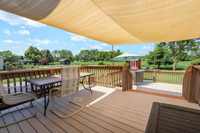 8181 Fawn Meadow Trl, Galesburg, MI 49053 - deck with outdoor dining space, a yard, and view of scattered trees