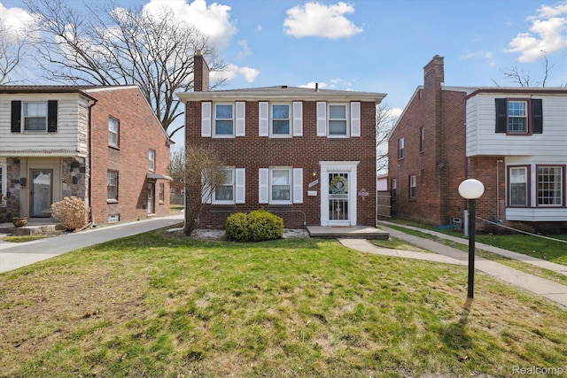19340 Appoline St, Detroit, MI 48235 - view of front facade featuring a front lawn, brick siding, and a chimney