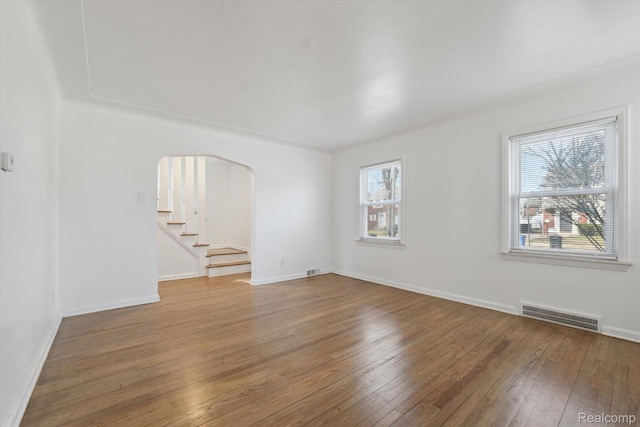 19340 Appoline St, Detroit, MI 48235 - unfurnished room featuring hardwood / wood-style flooring, arched walkways, and stairs
