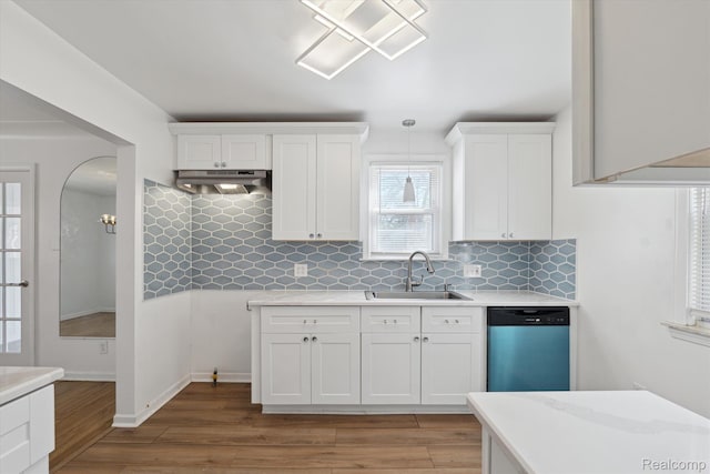 19340 Appoline St, Detroit, MI 48235 - kitchen with dishwasher, light countertops, under cabinet range hood, light wood finished floors, and decorative backsplash