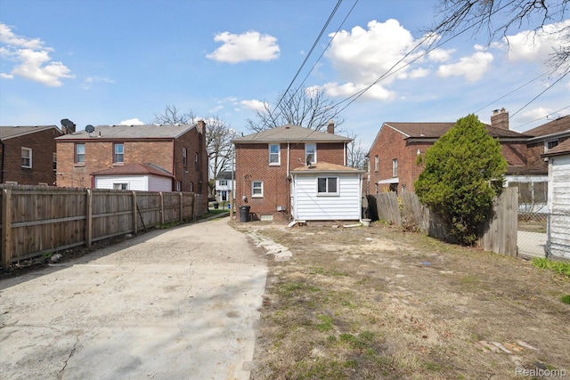 19340 Appoline St, Detroit, MI 48235 - rear view of property featuring driveway, brick siding, and a residential view