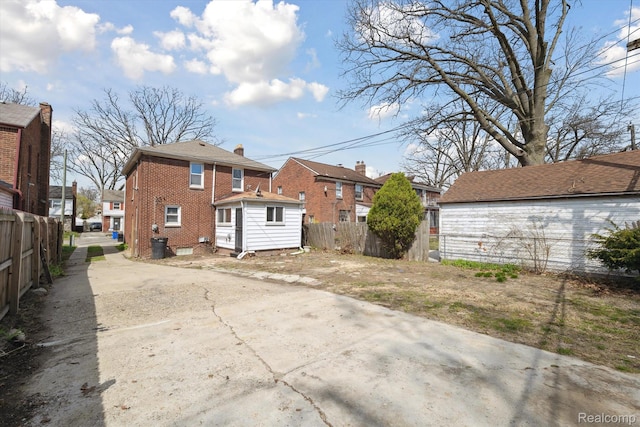 19340 Appoline St, Detroit, MI 48235 - back of property featuring brick siding, a residential view, and concrete driveway