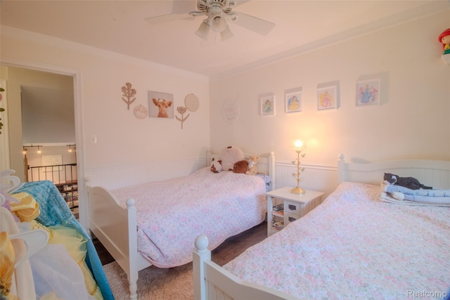 21102 Knudsen Dr, Grosse Ile, MI 48138 - bedroom featuring wainscoting, crown molding, and a ceiling fan