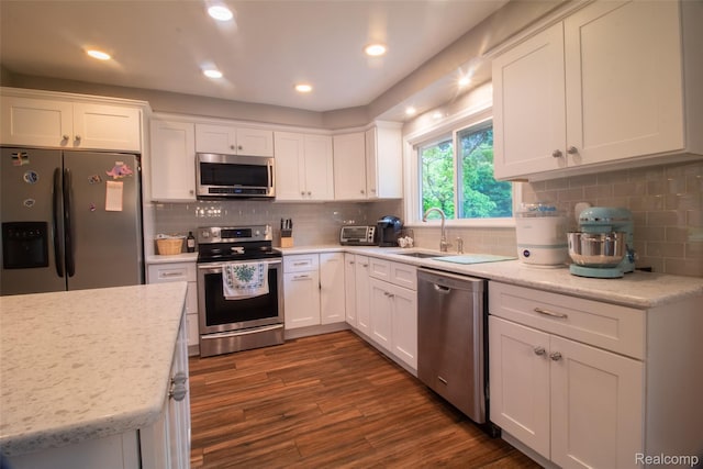 21102 Knudsen Dr, Grosse Ile, MI 48138 - kitchen featuring stainless steel appliances, white cabinets, decorative backsplash, and recessed lighting