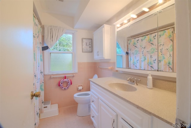 21102 Knudsen Dr, Grosse Ile, MI 48138 - bathroom with vanity, tile walls, a shower with shower curtain, tile patterned flooring, and a wainscoted wall