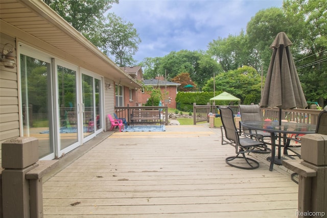 21102 Knudsen Dr, Grosse Ile, MI 48138 - wooden deck featuring outdoor dining space