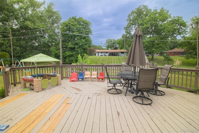 21102 Knudsen Dr, Grosse Ile, MI 48138 - wooden deck with outdoor dining area and a lawn