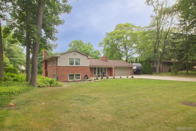 21102 Knudsen Dr, Grosse Ile, MI 48138 - tri-level home with a chimney, brick siding, concrete driveway, and a garage
