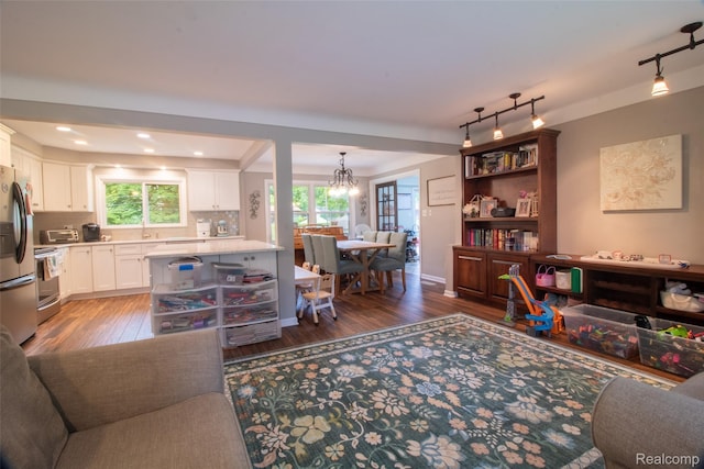 21102 Knudsen Dr, Grosse Ile, MI 48138 - living room featuring track lighting, light wood-style flooring, a chandelier, and recessed lighting