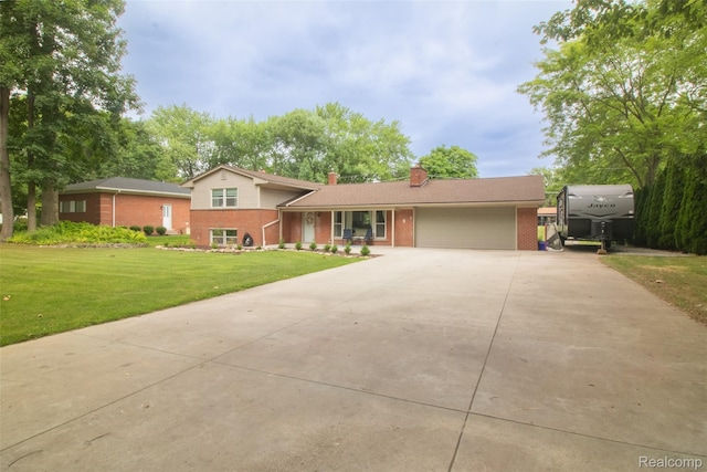 21102 Knudsen Dr, Grosse Ile, MI 48138 - tri-level home featuring brick siding, driveway, a chimney, and an attached garage