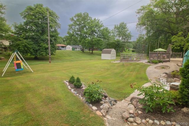 21102 Knudsen Dr, Grosse Ile, MI 48138 - view of grassy yard with a shed and a wooden deck