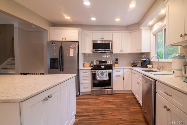 21102 Knudsen Dr, Grosse Ile, MI 48138 - kitchen featuring appliances with stainless steel finishes, white cabinetry, dark wood-style floors, and recessed lighting