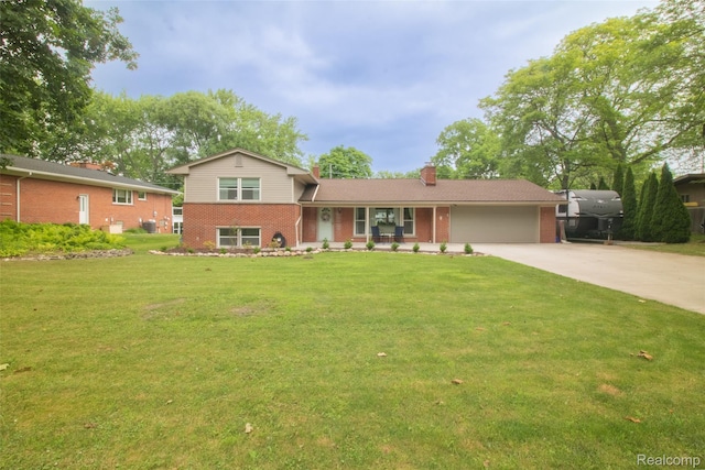 21102 Knudsen Dr, Grosse Ile, MI 48138 - split level home featuring brick siding, an attached garage, concrete driveway, and a chimney