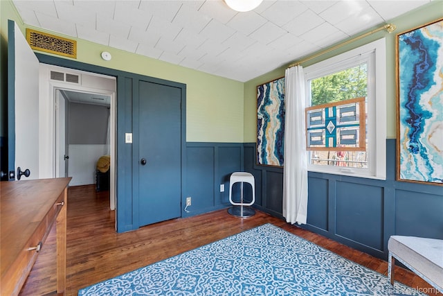6917 Belton St, Garden City, MI 48135 - interior space featuring dark wood finished floors, a decorative wall, wainscoting, and a closet