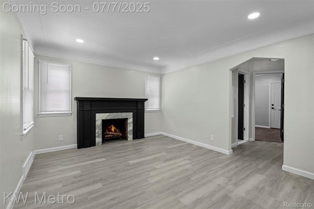 18258 Manor St, Detroit, MI 48221 - unfurnished living room featuring wood finished floors, a premium fireplace, recessed lighting, and ornamental molding