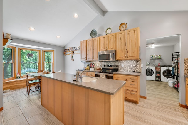 8361 9 Mile Rd, Big Rapids, MI 49307 - kitchen with stainless steel appliances, separate washer and dryer, backsplash, light wood finished floors, and recessed lighting