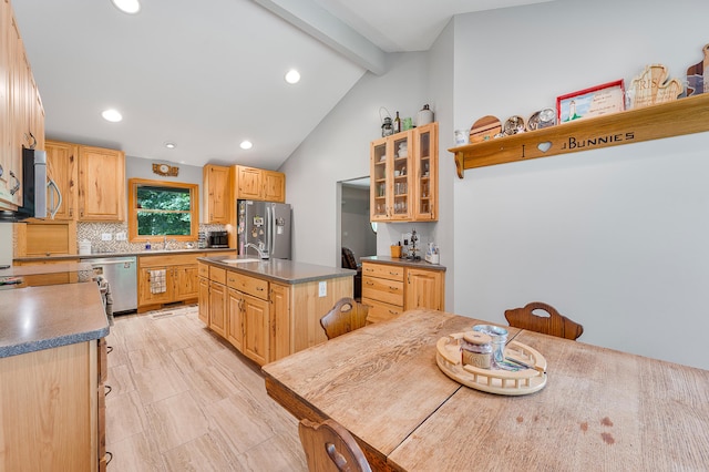 8361 9 Mile Rd, Big Rapids, MI 49307 - kitchen with stainless steel appliances, tasteful backsplash, recessed lighting, a center island with sink, and glass insert cabinets