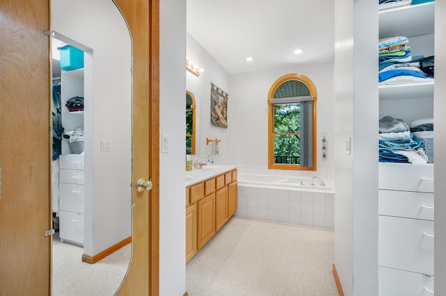 8361 9 Mile Rd, Big Rapids, MI 49307 - full bath featuring vanity, a garden tub, a walk in closet, and recessed lighting