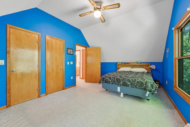 8361 9 Mile Rd, Big Rapids, MI 49307 - bedroom featuring vaulted ceiling, two closets, carpet flooring, and ceiling fan