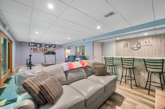 8361 9 Mile Rd, Big Rapids, MI 49307 - living area with wood finished floors, a paneled ceiling, and wooden walls
