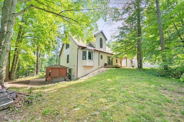 8361 9 Mile Rd, Big Rapids, MI 49307 - view of grassy yard with a deck