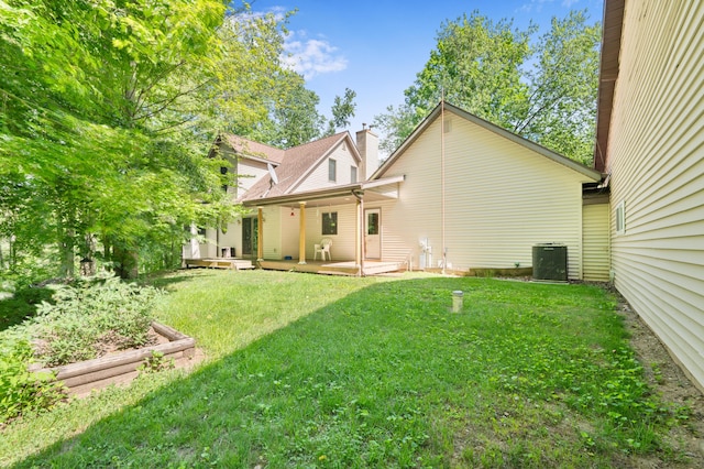 8361 9 Mile Rd, Big Rapids, MI 49307 - rear view of house featuring a chimney and a yard