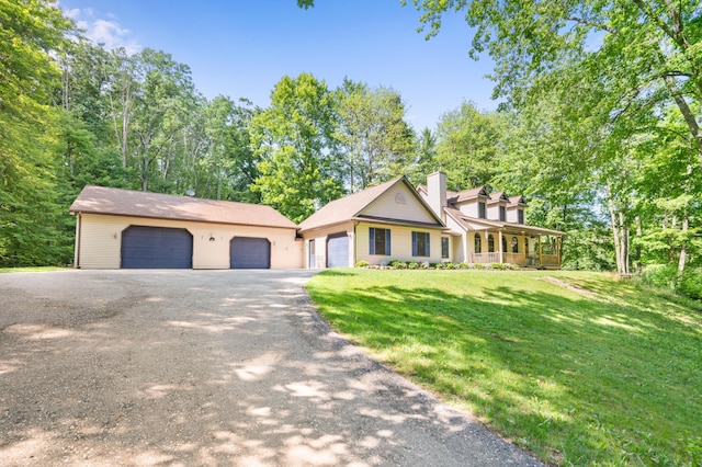 8361 9 Mile Rd, Big Rapids, MI 49307 - view of front of property featuring a garage, a front yard, a chimney, and covered porch