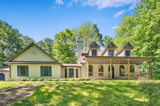 8361 9 Mile Rd, Big Rapids, MI 49307 - view of front of property with a chimney, a front lawn, and covered porch