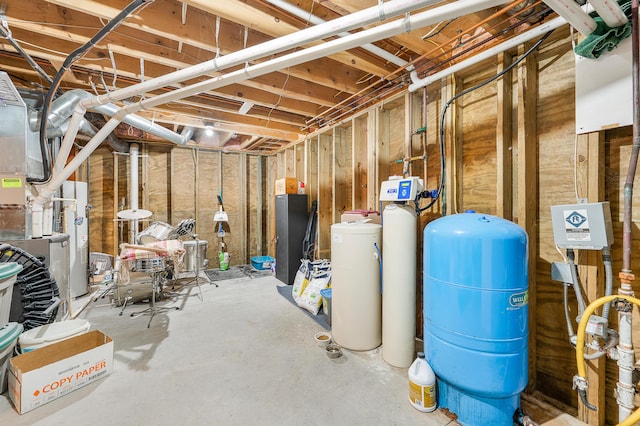 8361 9 Mile Rd, Big Rapids, MI 49307 - unfinished basement featuring a water pressure tank and a water softener system