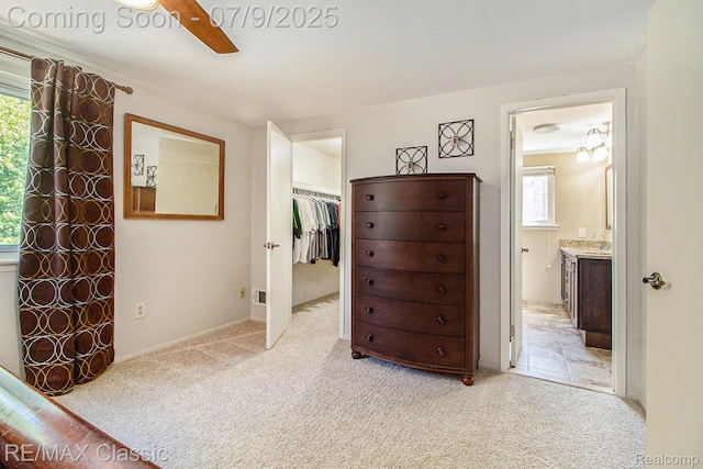 6706 Brookshire Dr, Canton, MI 48187 - bedroom featuring light colored carpet, ensuite bathroom, a spacious closet, and a ceiling fan