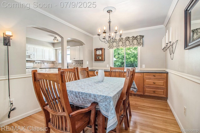 6706 Brookshire Dr, Canton, MI 48187 - dining room with a chandelier, arched walkways, light wood-type flooring, healthy amount of natural light, and ornamental molding