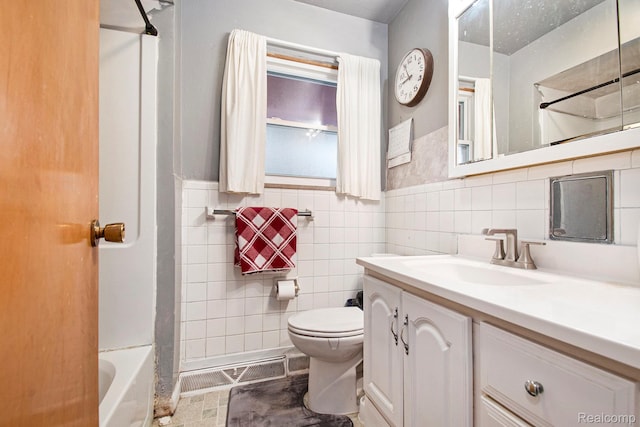 5178 Helga St, Saginaw, MI 48603 - bathroom featuring vanity, tile walls, and a wainscoted wall