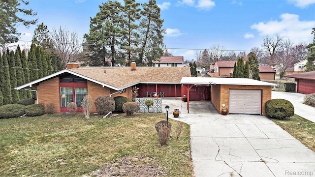 5178 Helga St, Saginaw, MI 48603 - view of front of house with a front yard, a chimney, driveway, and an attached garage