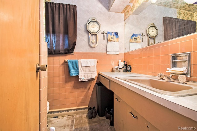 5178 Helga St, Saginaw, MI 48603 - bathroom featuring vanity, baseboard heating, and tile walls