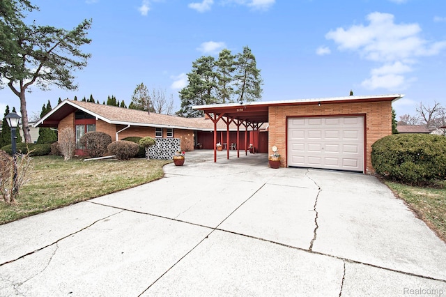 5178 Helga St, Saginaw, MI 48603 - single story home with a garage, concrete driveway, brick siding, and a front yard